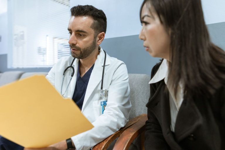 Doctor reviewing health records with an established patient during an office visit