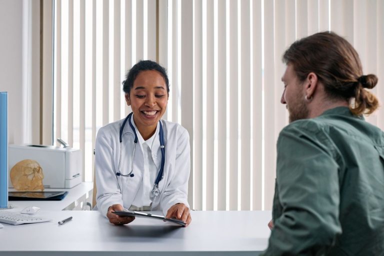 Doctor talking with an established patient during a follow-up office visit